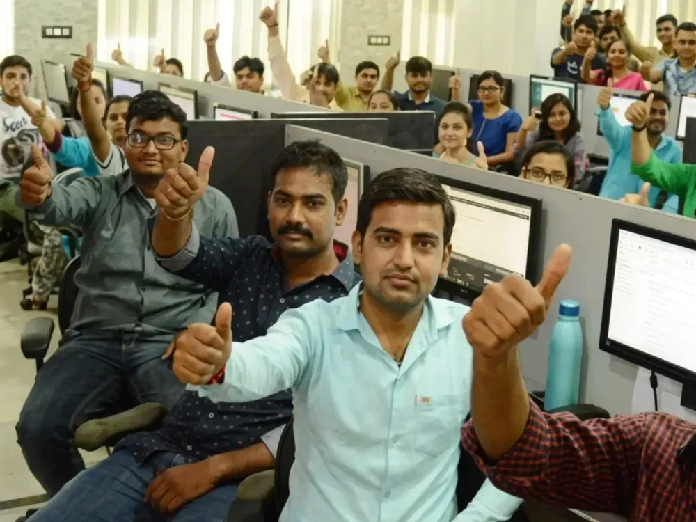 Keshav Infotech team members gathered in the studio, smiling and giving a thumbs up